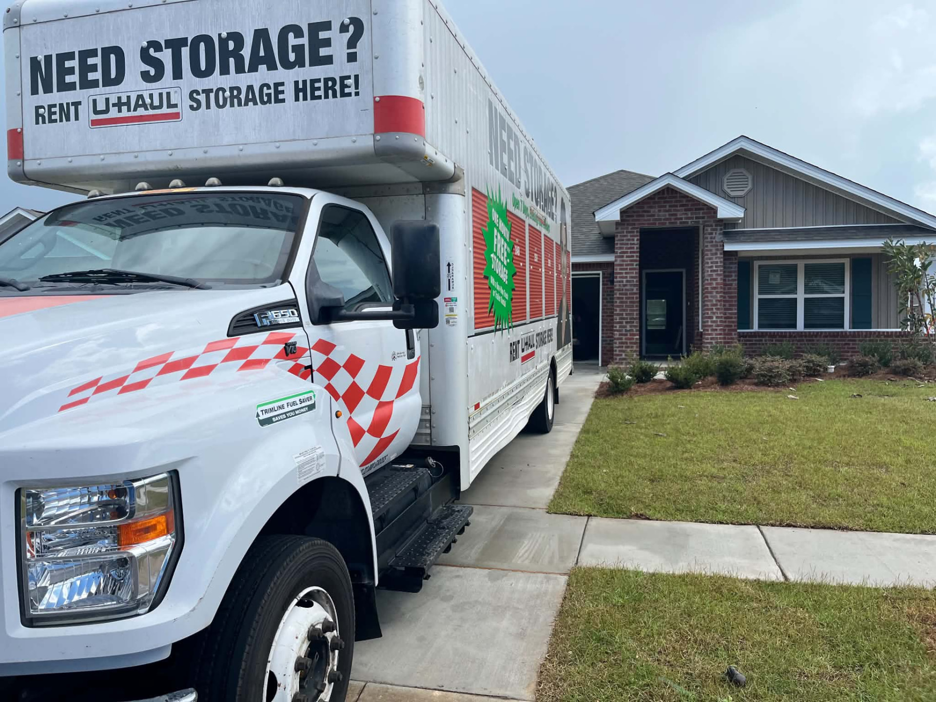 Moving truck parked at a suburban home ready to load