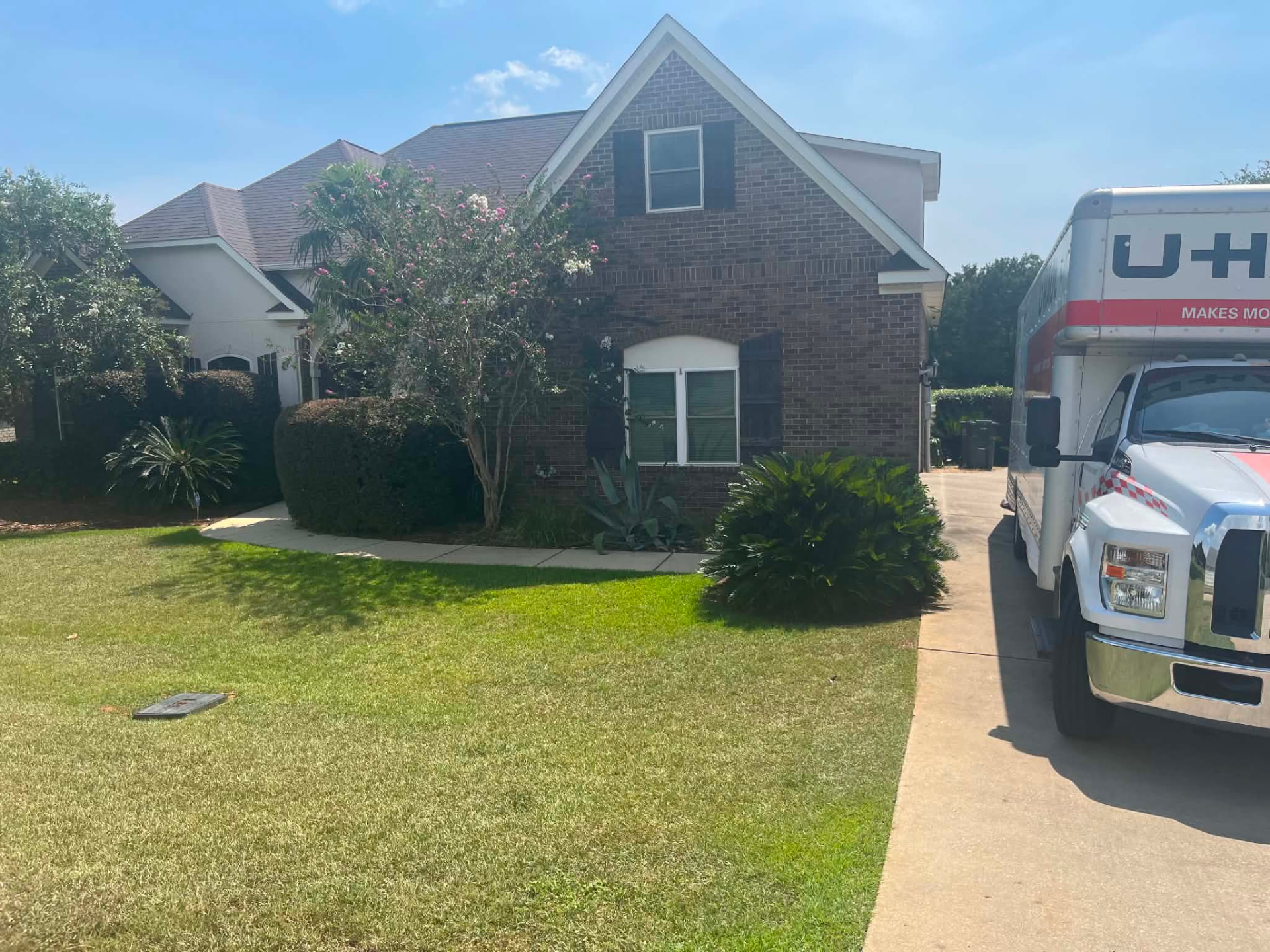 Moving truck parked at a brick home ready for a local move