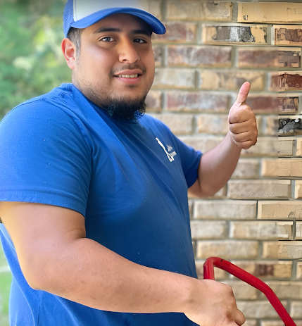 Uniformed crew member giving a thumbs up on the job