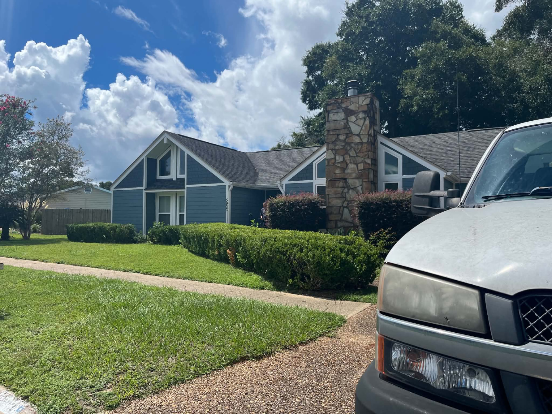 Moving truck parked in the driveway of a Gulf Coast home